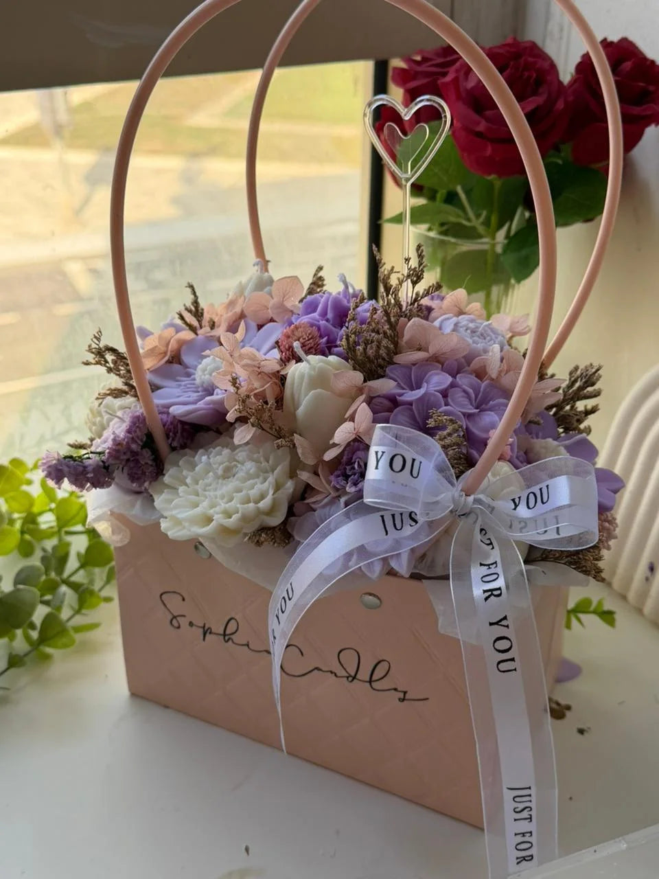 Lilac and pink candle bouquet in a Sophia branded gift bag