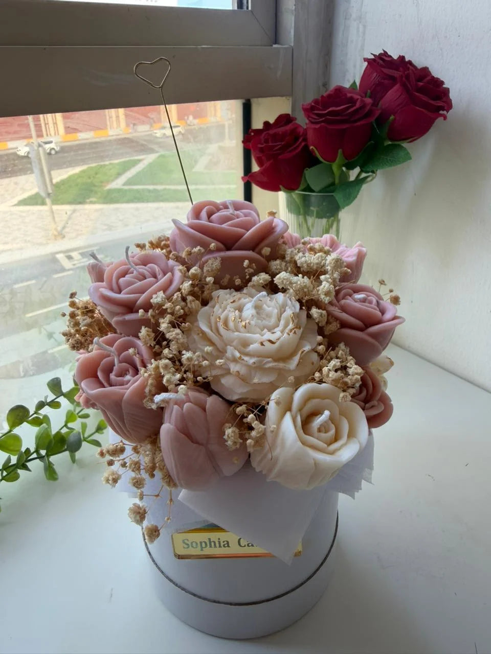 Pink and ivory rose candles in a round box