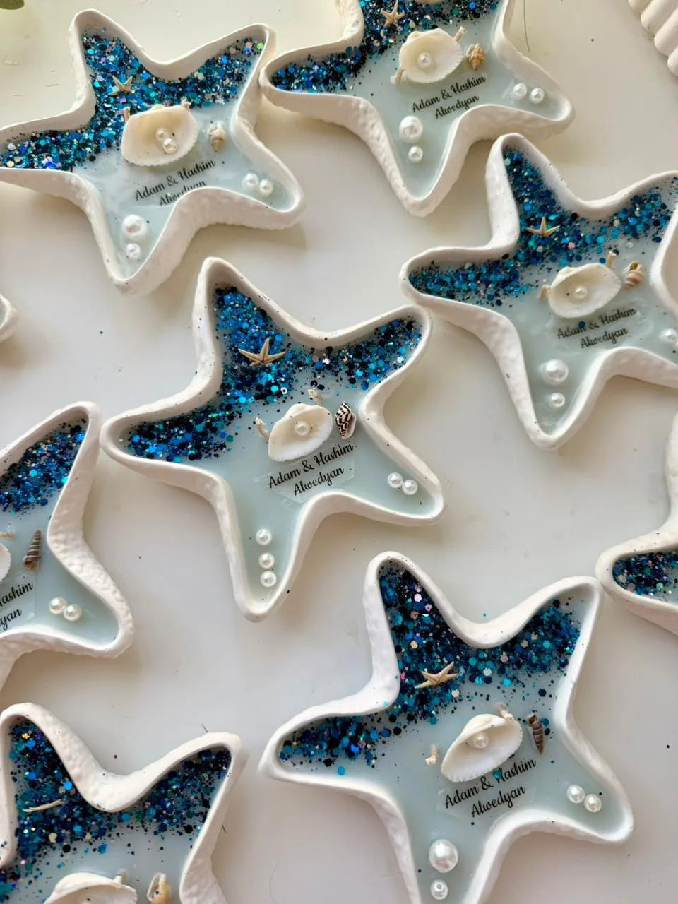 Aqua starfish candle favor with blue glitter, shells, and pearls