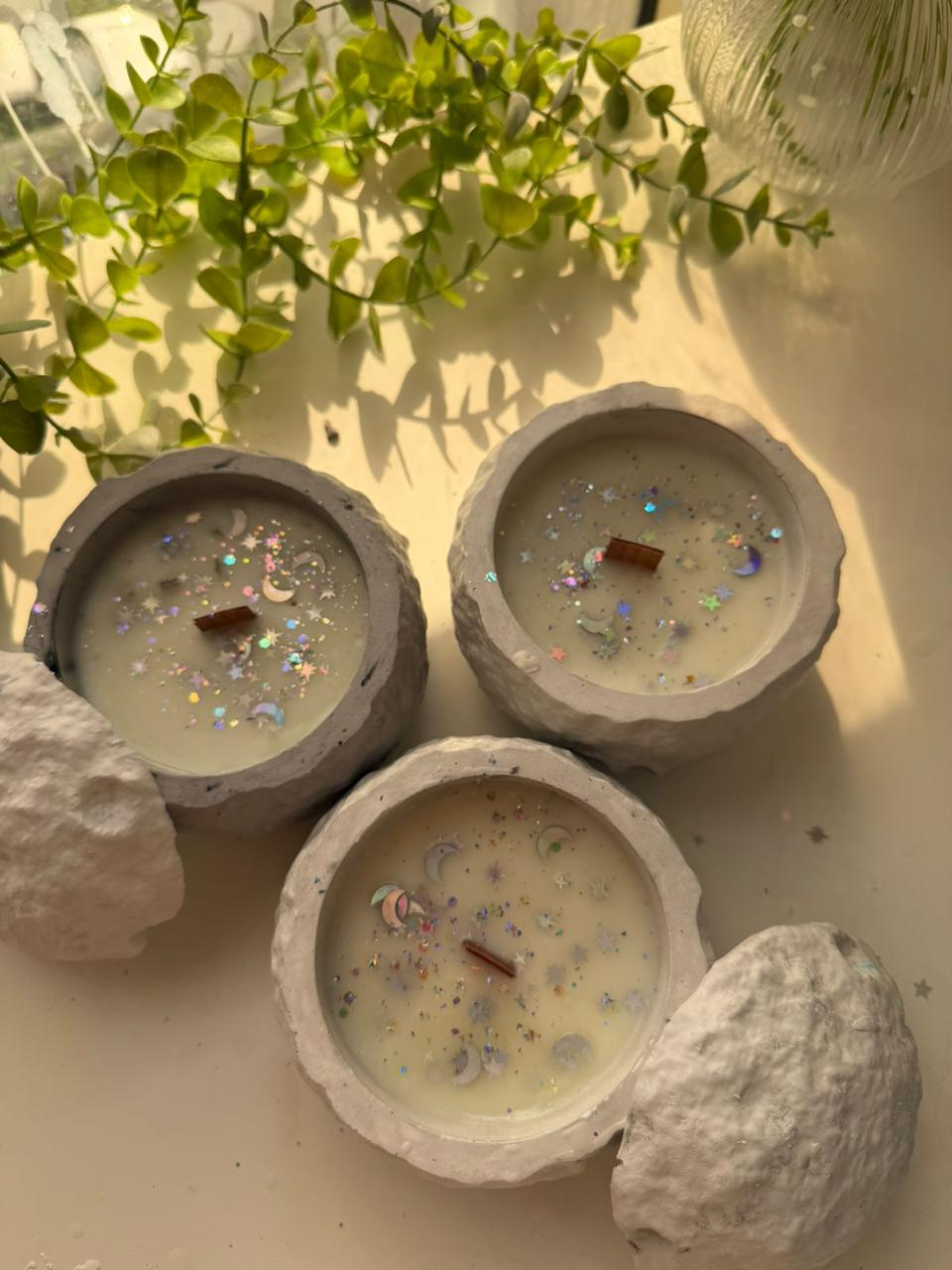 White cratered moon sphere candle with matching lid