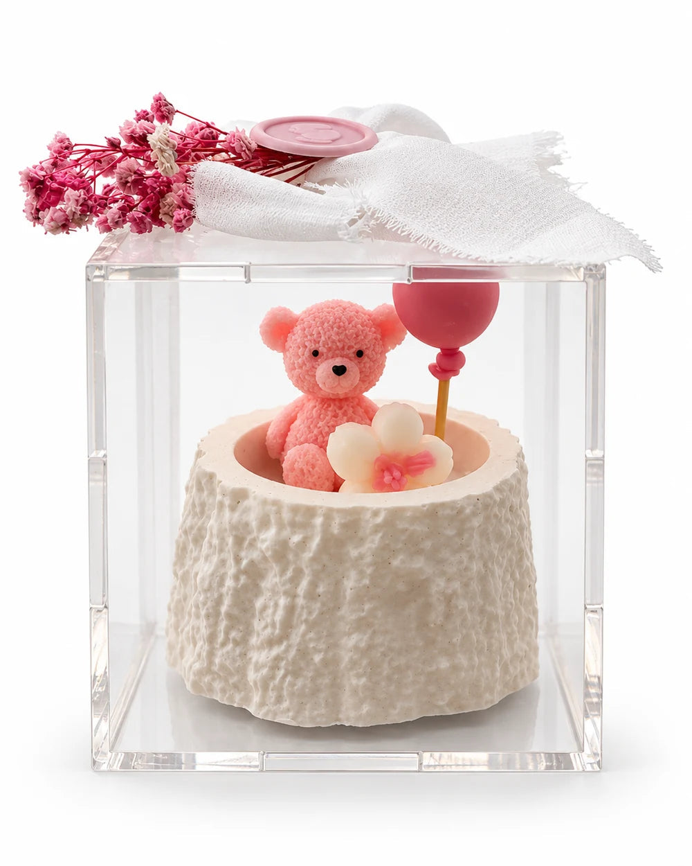 Pink teddy candle favor in a clear acrylic box